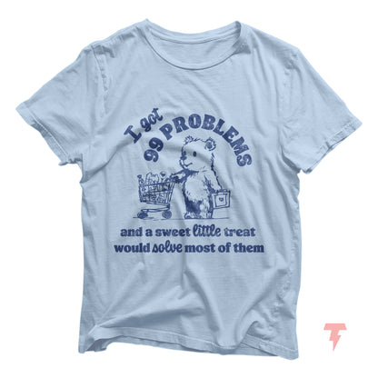 Vintage '99 Problems and a Sweet Little Treat' t-shirt, funny retro design on light blue fabric, perfect for casual wear.