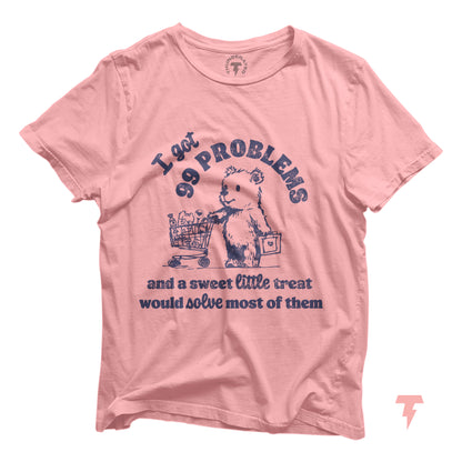 Pink t-shirt with bear cartoon and humorous text 'I got 99 problems and a sweet little treat would solve most of them'.