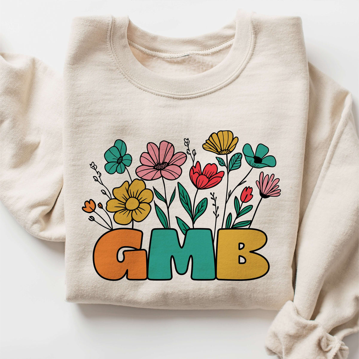 Unisex crewneck sweatshirt with colorful flower design and bold 'GMB' text, made from soft, comfy fabric for stylish warmth.