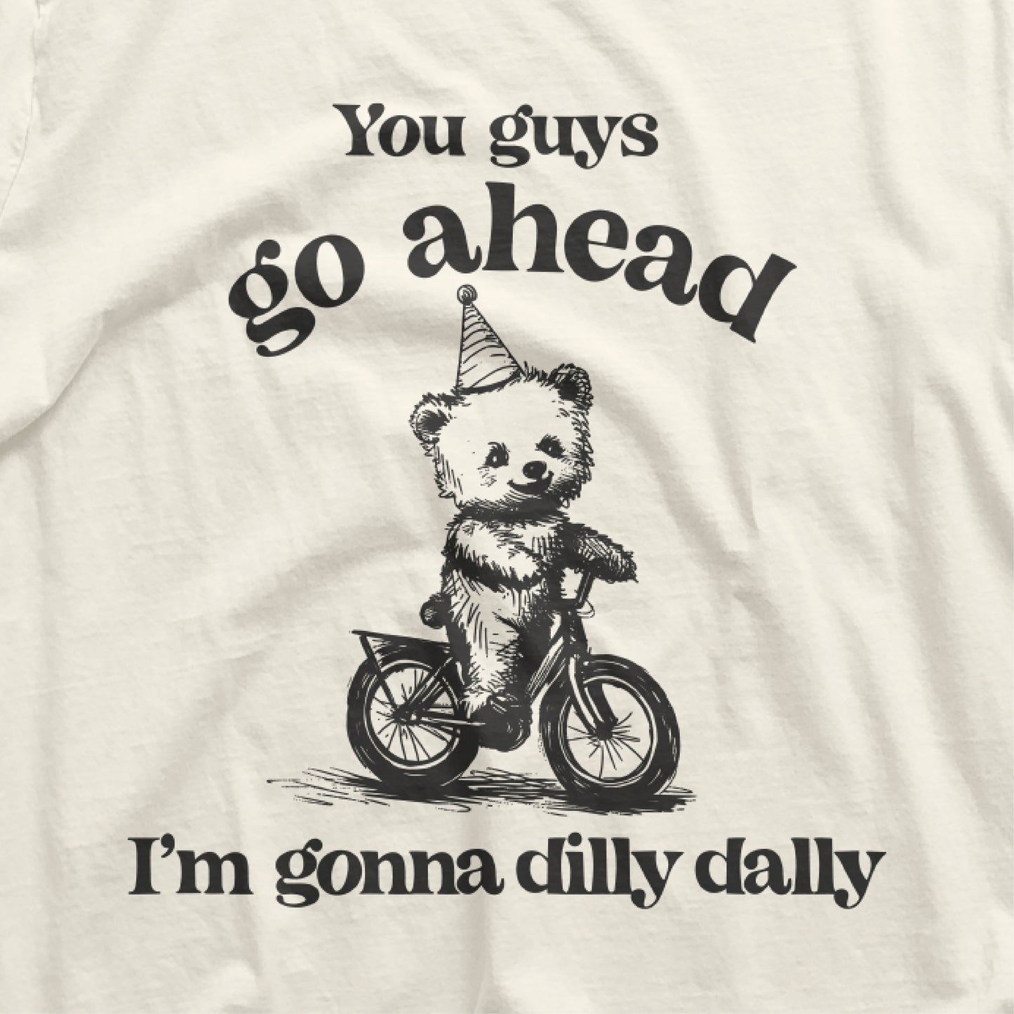 Go Ahead I Am Gonna Dilly Dally t-shirt with bear riding bike graphic and funny 90s saying, perfect for free spirits and hobbyists.