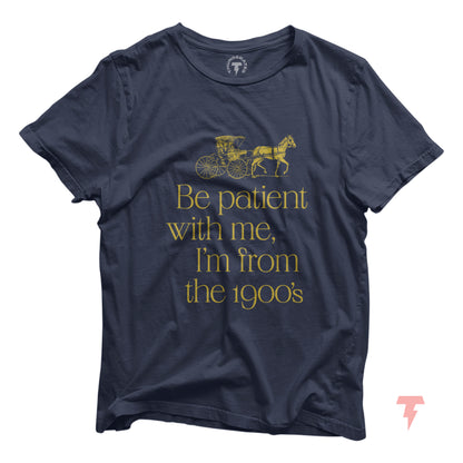Navy blue t-shirt with 'Be patient with me, I'm from the 1900's' text and vintage carriage graphic, ideal for 1900s birthday gift.