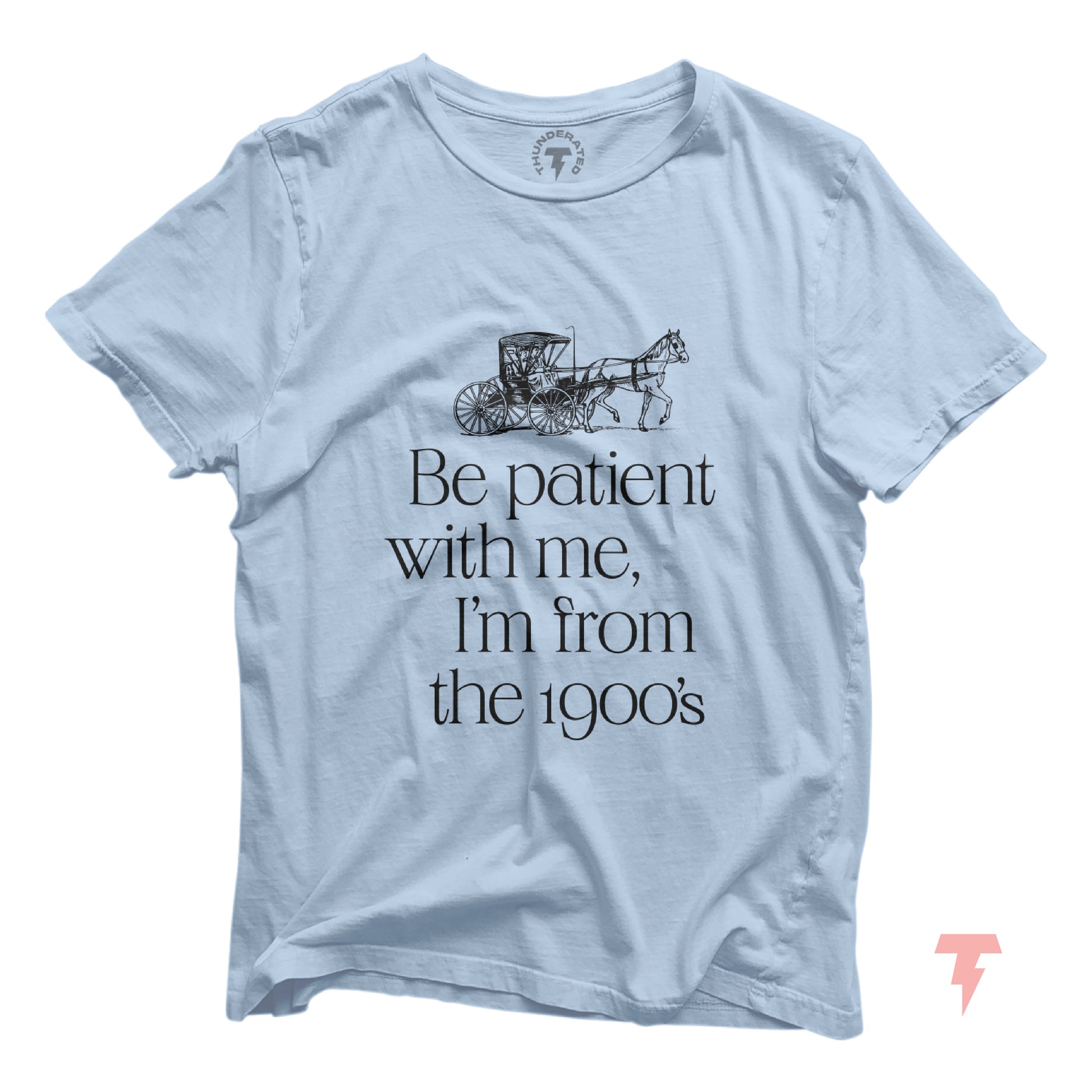Light blue t-shirt with "Be patient with me, I'm from the 1900's" print, featuring a horse-drawn carriage graphic.