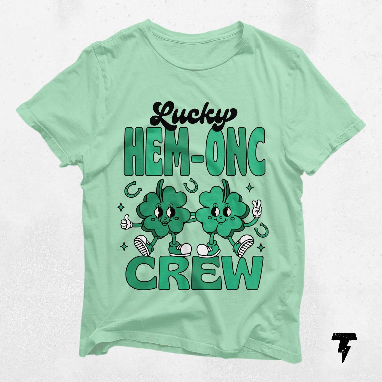 Lucky HEM-ONC Crew St. Patrick's Day shirt with cheerful shamrock design for nurses and oncologists. Festive nursing tee.