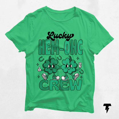 Green Lucky HEM-ONC Crew St. Patrick's Day shirt for oncology nurses featuring cheerful shamrocks and festive design.