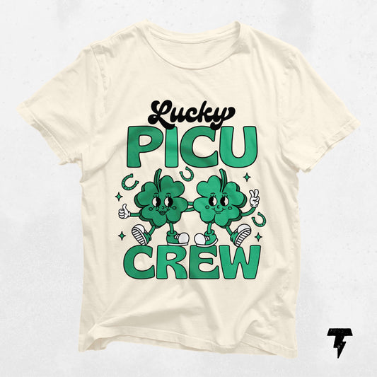 "Lucky PICU Crew St. Patrick's Day shirt celebrating pediatric care with cartoon clovers, perfect for ICU staff."