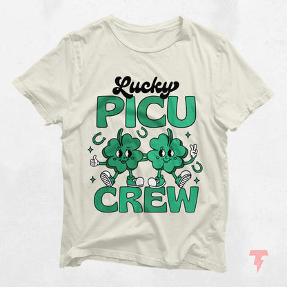 Lucky PICU Crew St. Patrick's Day shirt featuring cartoon clovers for pediatric ICU staff, 100% cotton, perfect gift idea.