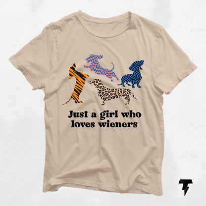 Beige 'Just a Girl Who Loves Wieners' dachshund graphic tee with colorful dog silhouettes, perfect gift for dog moms.