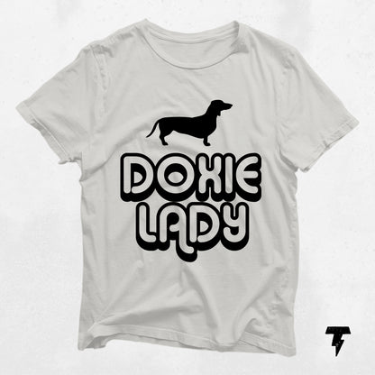 White Doxie Lady Dachshund shirt with black print for dog lovers, unisex tee, perfect gift for dog moms, made from soft cotton.