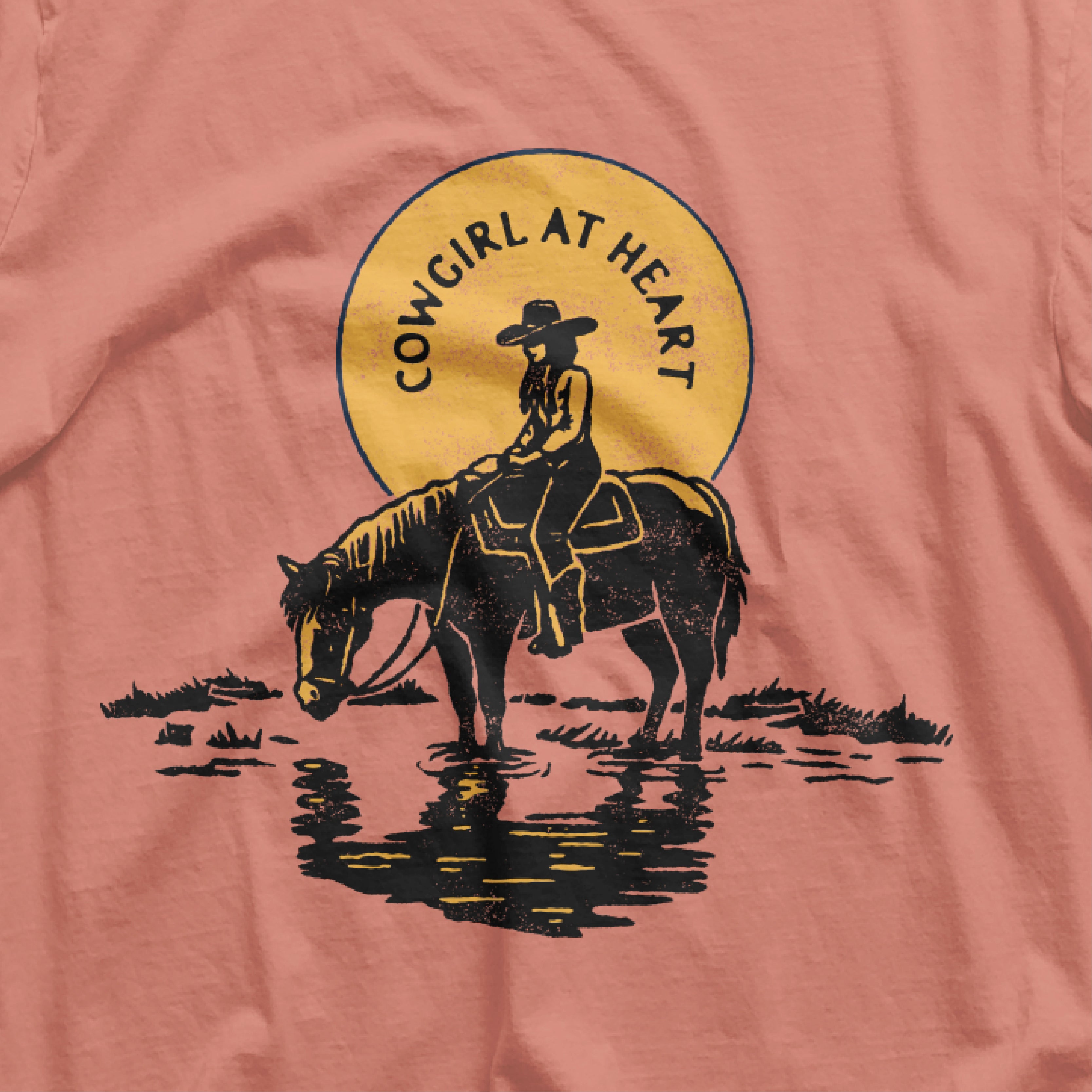 a pink shirt with a picture of a cowboy on a horse