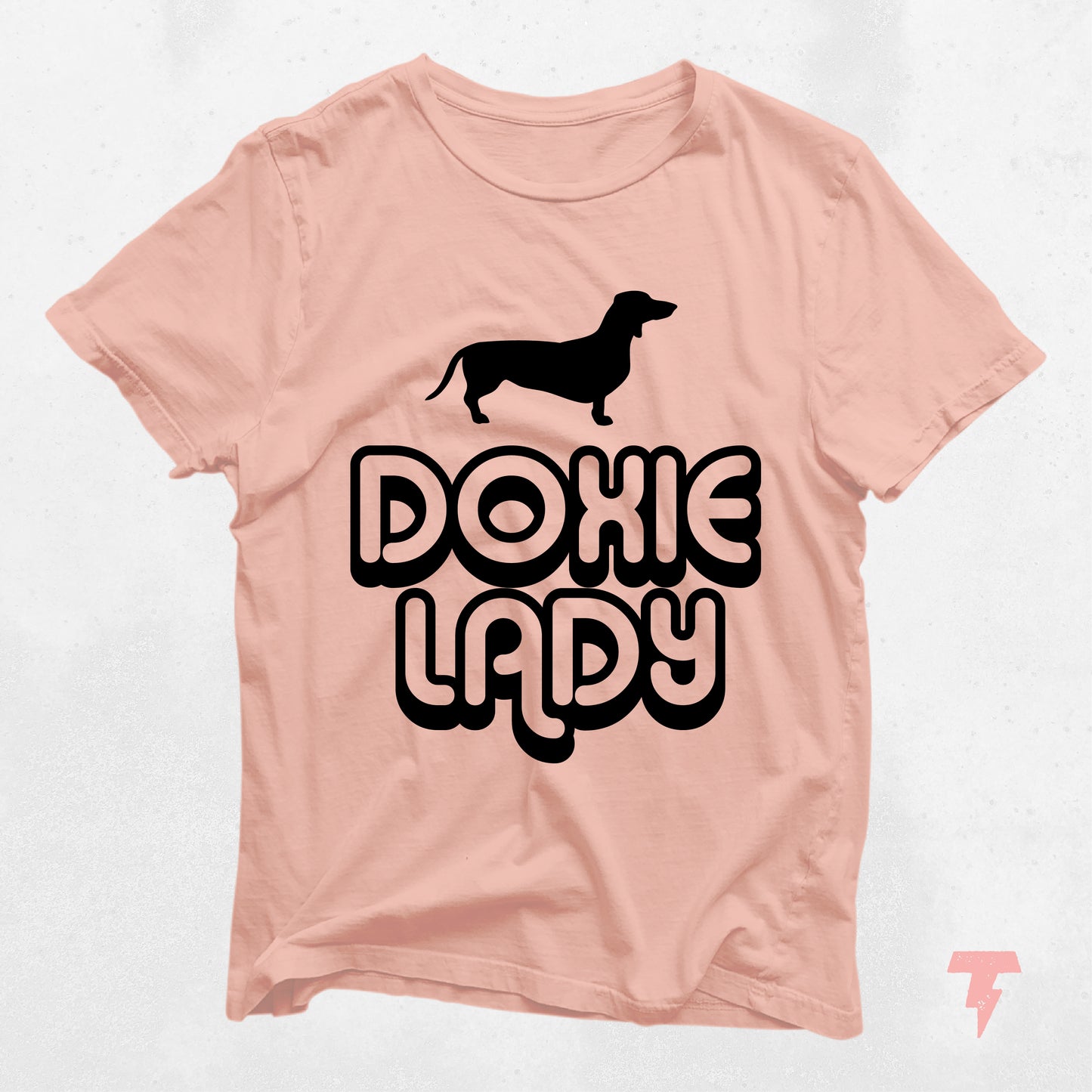 Peach Doxie Lady shirt featuring a black dachshund silhouette, perfect gift for dog moms and dachshund lovers.