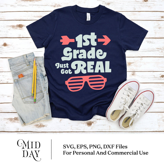 Navy shirt with '1st Grade Just Got Real' design, cut files for Cricut, next to denim shorts and white sneakers, perfect for back to school.