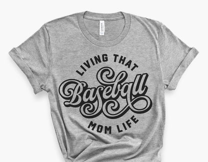 Gray t-shirt with 'Living That Baseball Mom Life' design in vintage script style, perfect for baseball fan apparel.