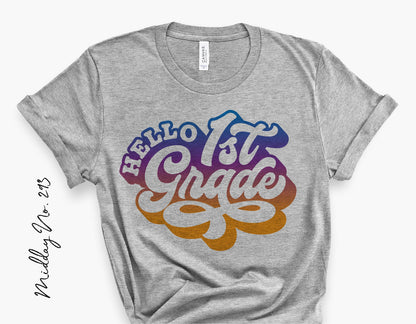 Gray t-shirt with 'Hello 1st Grade' colorful retro design, perfect for first day of school or teacher gifts.