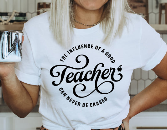 Woman wearing a T-shirt with 'The Influence of a Good Teacher Can Never Be Erased' text in decorative font, holding a mug.
