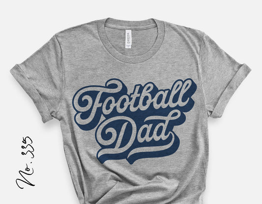 Gray t-shirt with 'Football Dad' in vintage blue script, perfect for youth sports fans. Cricut and Silhouette compatible. No. 335