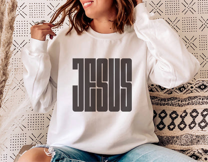 Woman wearing a white sweatshirt with bold 'JESUS' print, showcasing Christian faith and casual style.