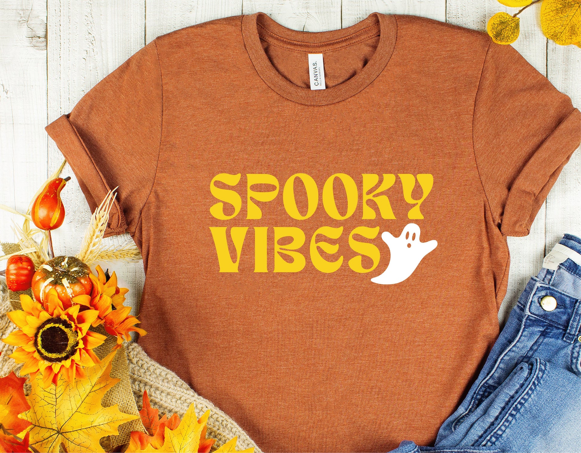 Halloween Spooky Vibes t-shirt featuring a cute ghost design, perfect for fall decor, costume shirts, and Cricut cut file projects.
