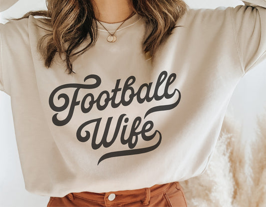 Woman wearing a sweatshirt with 'Football Wife' vintage design, ideal for sports fans and DIY craft projects. Includes SVG and digital files.