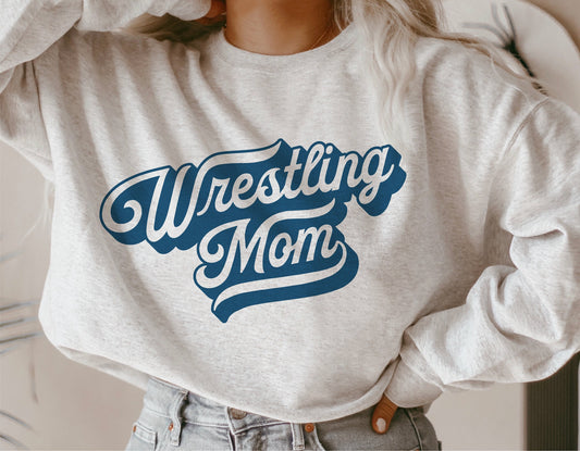 Person wearing a gray sweatshirt with 'Wrestling Mom' design, ideal for Cricut and Silhouette crafting, school spirit apparel.
