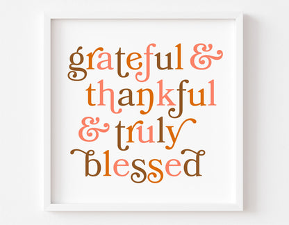 Framed artwork with the text 'grateful & thankful & truly blessed' in autumn colors.