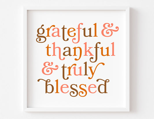 Framed artwork with the text 'grateful & thankful & truly blessed' in autumn colors.