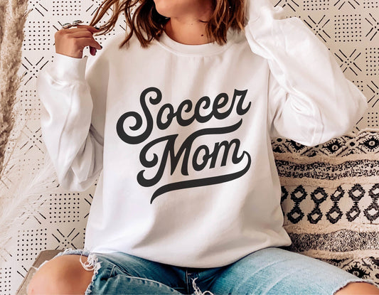 Soccer Mom shirt worn by a woman, featuring a stylish black script design, perfect for sports fans and family enthusiasts.