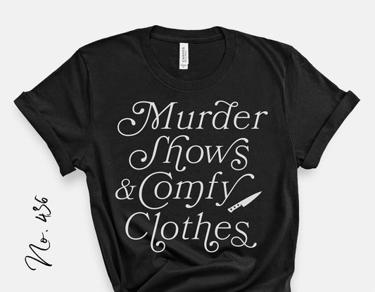 Black t-shirt with 'Murder Shows & Comfy Clothes' text design featuring a knife graphic, suitable for Halloween and true crime enthusiasts.