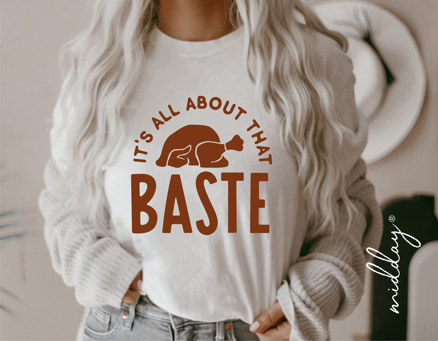 Woman wearing "It's All About That Baste" Thanksgiving t-shirt with turkey graphic, perfect for fall and autumn celebrations.