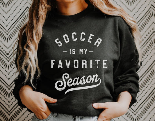 Person wearing black sweatshirt with 'Soccer is My Favorite Season' text, ideal for soccer moms or fans. Perfect for Cricut or Silhouette projects.