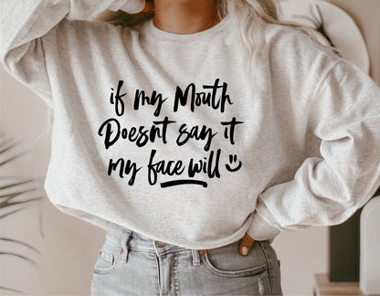 Person wearing a sweatshirt with humorous text: 'If My Mouth Doesn't Say It, My Face Will'