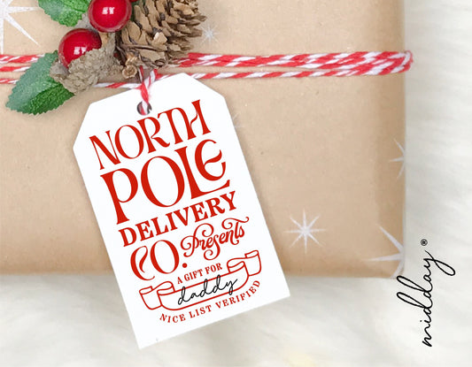 Christmas gift with North Pole Delivery tag featuring red text and festive decorations.
