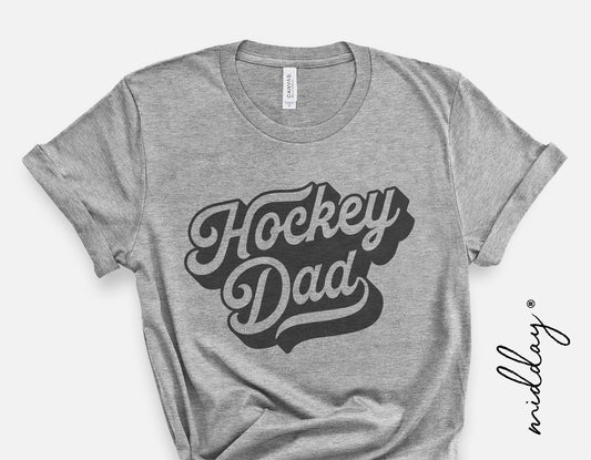 Gray t-shirt with bold lettering 'Hockey Dad', ideal for hockey fan apparel.