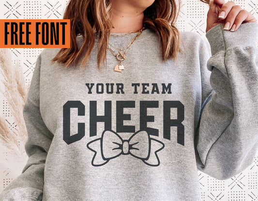 Cheerleader sweatshirt with 'Your Team Cheer' and bow graphic, featuring a free font promotion, ideal for cheer gifts and Cricut projects.