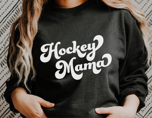 Woman wearing a black sweatshirt with 'Hockey Mama' text in white, ideal for hockey moms and fans, suitable for Cricut and sublimation projects