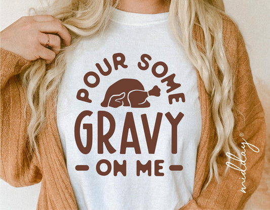 Woman wearing funny Thanksgiving shirt with 'Pour Some Gravy On Me' design, fall fashion SVG cut file for Cricut and Silhouette.