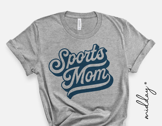 Gray t-shirt with vintage 'Sports Mom' graphic in bold blue lettering, suitable for sports fans and mom enthusiasts.