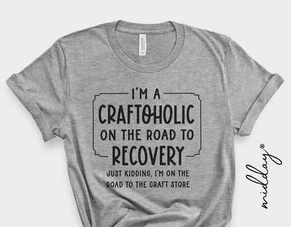 Gray t-shirt with 'I'm a Craftoholic on the road to recovery, just kidding, I'm on the road to the craft store' text design.