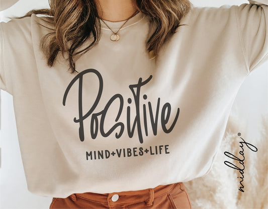 Woman wearing sweatshirt with 'Positive Mind Vibes Life' inspirational message, perfect for motivational and teacher quote lovers.