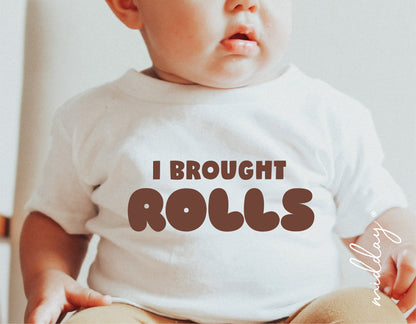 Baby wearing 'I Brought Rolls' Thanksgiving shirt, perfect for Cricut and Silhouette crafting projects.