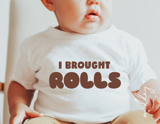 Baby wearing 'I Brought Rolls' Thanksgiving shirt, perfect for Cricut and Silhouette crafting projects.