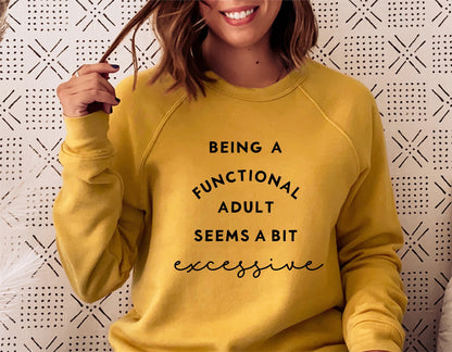 Woman wearing a yellow sweatshirt with 'Being a functional adult seems a bit excessive' text. Sarcastic design for new parents.
