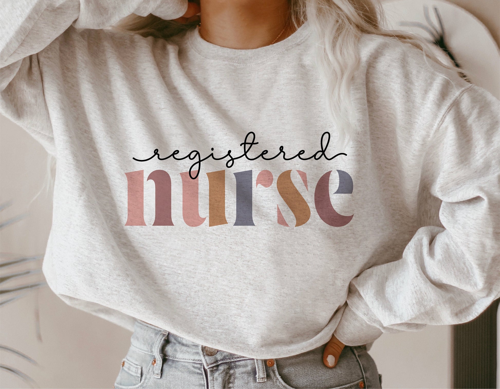 Cozy sweatshirt with 'Registered Nurse' text in colorful letters, ideal for nurse appreciation gifts or casual wear.
