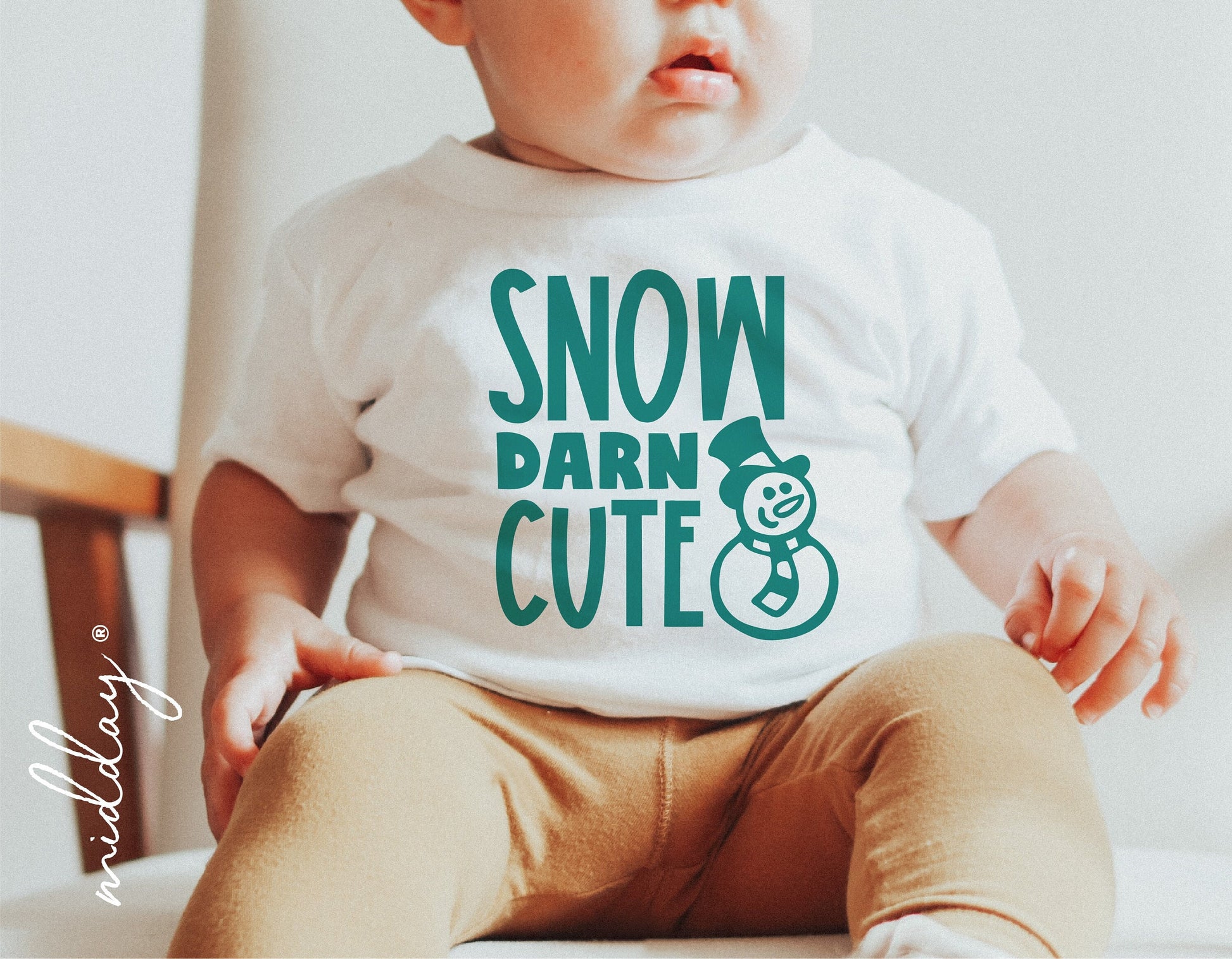 Baby wearing a 'Snow Darn Cute' Christmas shirt with snowman graphic, perfect for holiday decor and Cricut cut files.