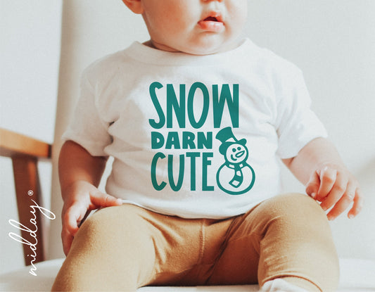 Baby wearing a 'Snow Darn Cute' Christmas shirt with snowman graphic, perfect for holiday decor and Cricut cut files.