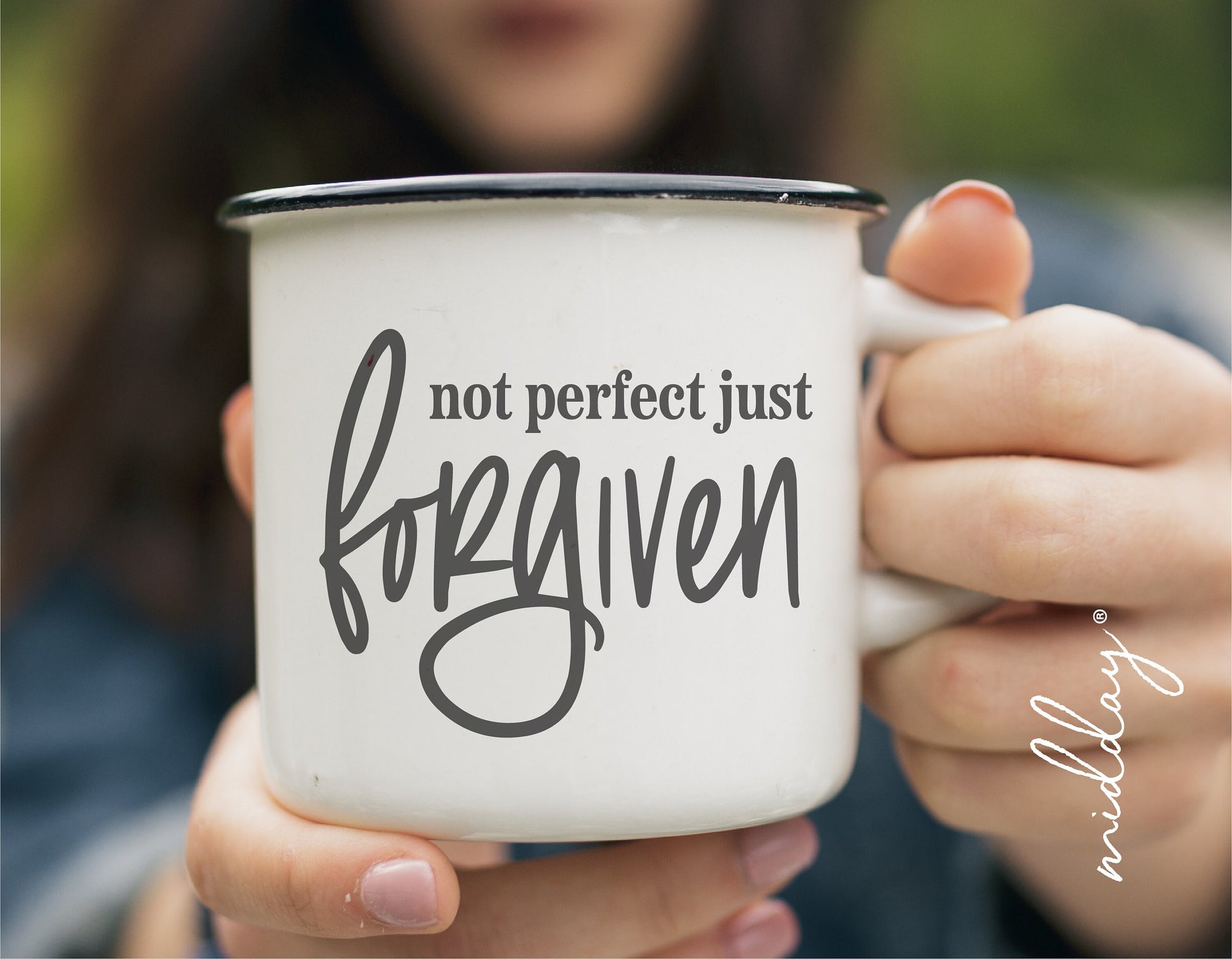 Close-up of a white mug with the quote 'not perfect just forgiven' printed in black, emphasizing Christian and forgiveness themes.