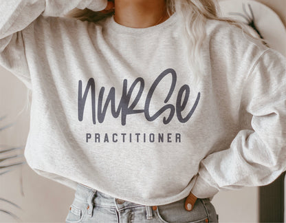 Woman wearing a white sweatshirt with 'Nurse Practitioner' text, perfect for nurse appreciation gifts and personalized Cricut projects.