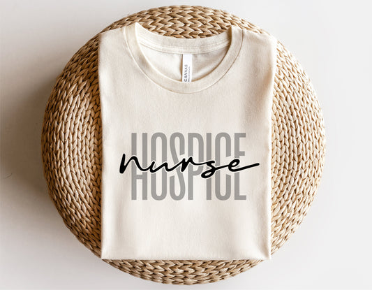 Hospice nurse t-shirt on woven placemat, featuring stylish text design for medical professionals.