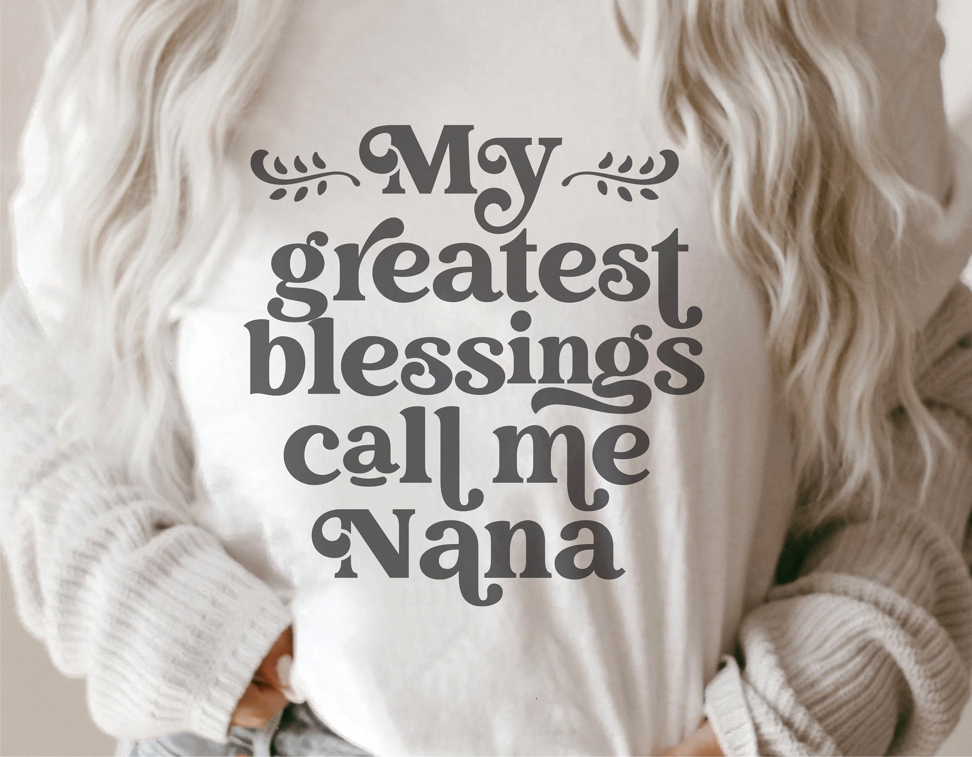 Woman wearing 'My Greatest Blessings Call Me Nana' shirt, ideal for Mother's Day gifts, featuring Cricut and Silhouette compatible design.