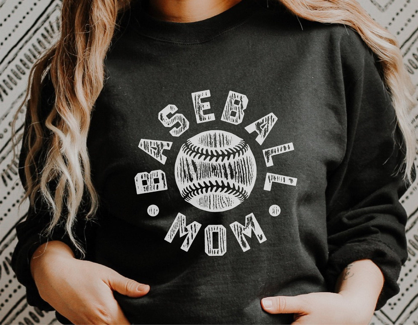 Person wearing a black shirt with "Baseball Mom" and a baseball graphic design, perfect for sports fans and Cricut projects.