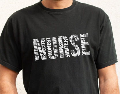 Black t-shirt with word art spelling 'Nurse' using words like compassionate, respectful, honest, and optimistic.